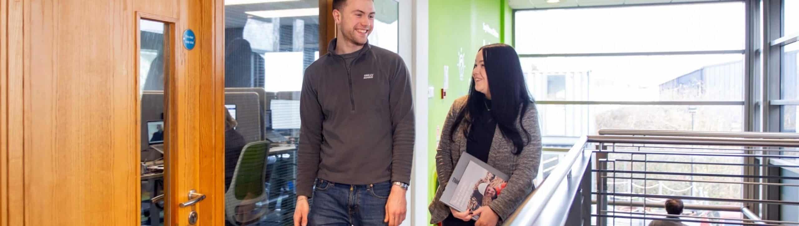 Employees at Smiley Monroe having a conversation in a corridor